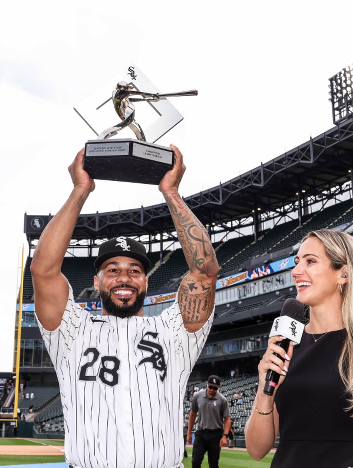 Leury Garcia celebrating with the Home Run Derby trophy