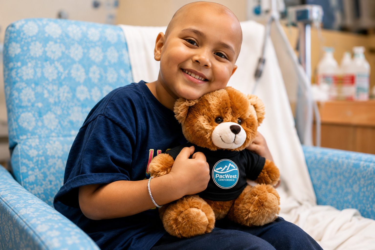 Child hugging a PacWest custom teddy bear